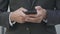 Male hands holding black smartphone and typing on screen