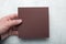 Male hands holding brown Square Flyer / Invitation Mock-Up