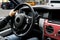 Male hands holding car steering wheel. Hands on steering wheel of a car driving. Young Man driving a car inside cabin. Multimedia