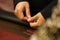 Male hands holding casino playing chips of different denominations over a roulette table