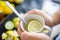 Male hands holding a cup of lemon tea above lime slices