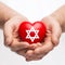 Male hands holding heart with star of david