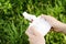 Male hands holding a quadrocopter remote on a background of grass. The concept of modern technology, flying.