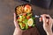 Male hands holding takeaway lunch box with healthy food