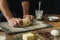 Male hands knead dough cooking cross buns home kitchen