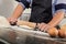 Male hands kneading dough sprinkled with flour table