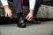 Male hands lace up the shoes close-up.