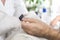 Male hands during the manicure treatment at the beauty salon.