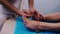 Male hands massaging patient\'s feet
