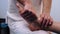 Male hands massaging patient\'s feet