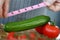 Male Hands Measure Green Ripe Cucumber Length