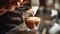 male hands pouring milk and preparing fresh cappuccino