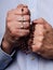 Male hands praying holding a rosary with Jesus Christ in the cross or Crucifix on black background.