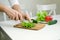 Male hands prepairing salad. Cutting salat