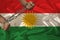 Male hands of a prisoner in iron chains against the background of the national flag of kurdistan, rojava, concept of political