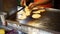 Male hands quickly flipping tortillas on a griddle