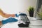 Male hands in rubber gloves wipe the table and keyboard from the computer. Disinfection in the office during the COVID-19