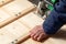 Male hands sawing boards with a circular saw