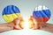 Male hands show their fists against the background of the flags of Ukraine and Russia. The concept of power struggle, conflict of