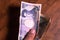 Male hands showing banknotes from Japan on a wooden background