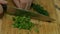 Male hands slicing green onions. Russian cuisine.