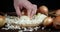 Male hands slicing onion on cutting Board.