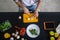 Male hands slicing porcini mushrooms on a cutting board.