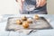 Male hands sprinkle powdered sugar homemade cupcakes