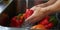 Male hands washing red pepper under stream water in the sink , concept of Spraying water