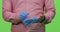 A male hands wearing blue color medical gloves in chroma studio