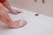 Male hands wipe the cement dust after grouting ceramic tiles with a rag