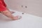 Male hands wipe the dust after grouting ceramic tiles