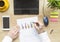 Male hands working on modern laptop. Office desktop on wooden background. Accounts balance