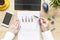 Male hands working on modern laptop. Office desktop on wooden background. Accounts balance