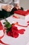 Male hands wrapping Valentine handmade present in paper with red