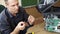 A male handyman inspects a printer before starting repairs at the service center.