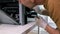 A male handyman inspects a printer before starting repairs at the service center.