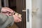 Male handyman worker wood door lock installation or repairing