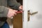 Male handyman worker wood door lock installation or repairing