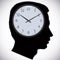 Male head silhouette with watch instead of brains.