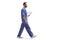 Male health worker in a blue uniform walking and holding a clipboard