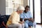 Male health worker with digital tablet discussing with caucasian senior woman over medication dose