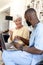 Male health worker with digital tablet discussing with caucasian senior woman over medication dose