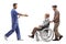 Male health worker walking and greeting and elderly patient in a wheelchair