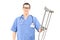 Male healthcare professional holding crutches