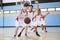 Male High School Basketball Team Dribbling Ball On Court