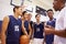 Male High School Basketball Team Having Team Talk With Coach