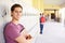 Male High School Student Standing By Lockers