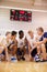 Male High School Volleyball Team Having Team Talk From Coach