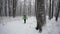 Male hiker in the forest during a winter day.